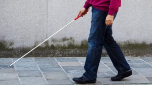 A blind holding a white cane