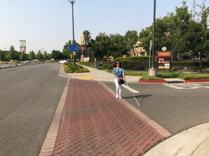 blind person at the center of the road while crossing the street