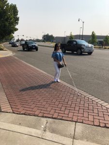 Blind during mobility training at the center of the street